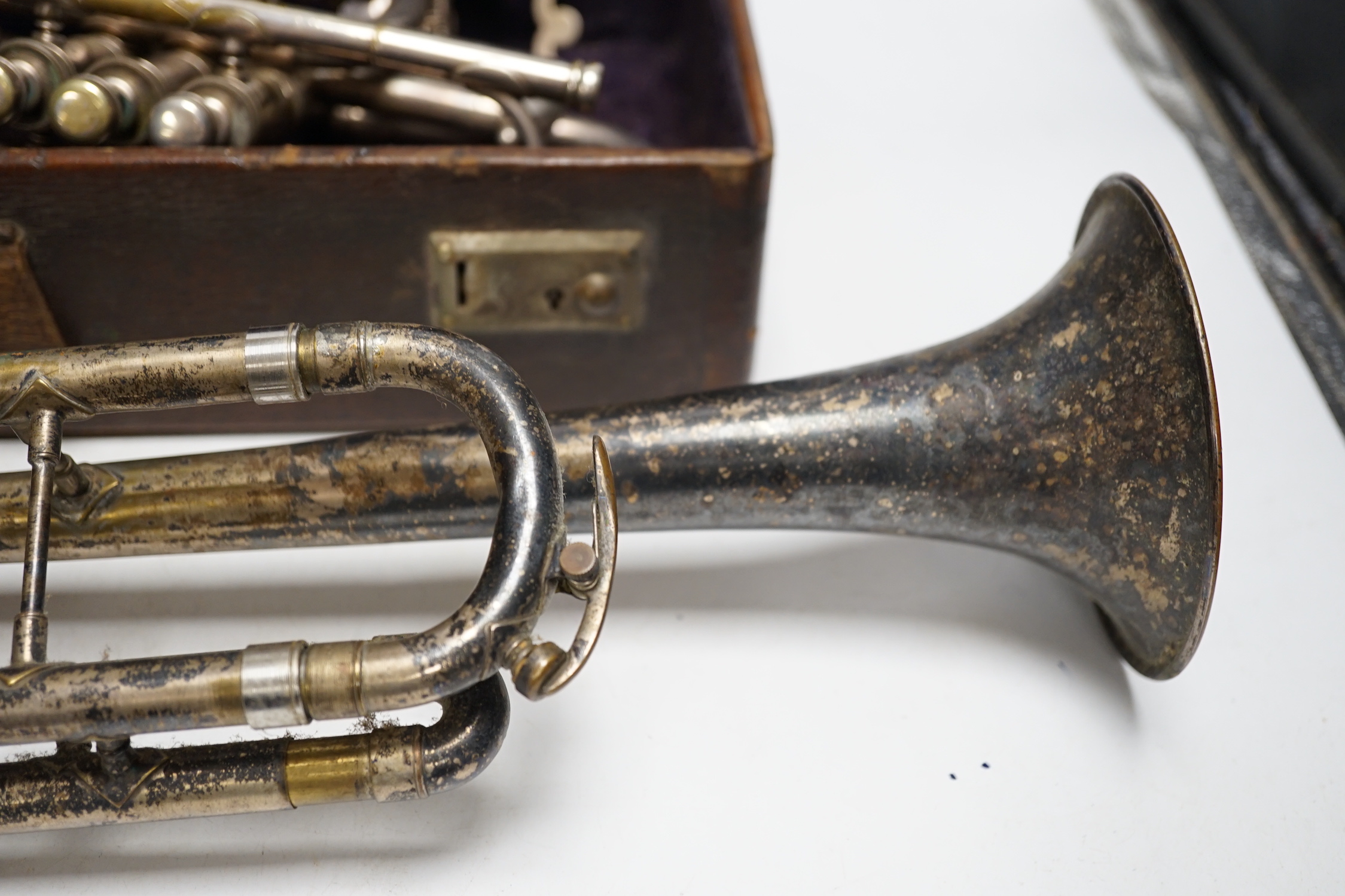 A cased Hawkes & Son cornet, bell engraved with ‘Excelsior Soncrous Class A’ and an ‘American Standard High Grade’ trumpet, with a brass mute and three mouthpieces